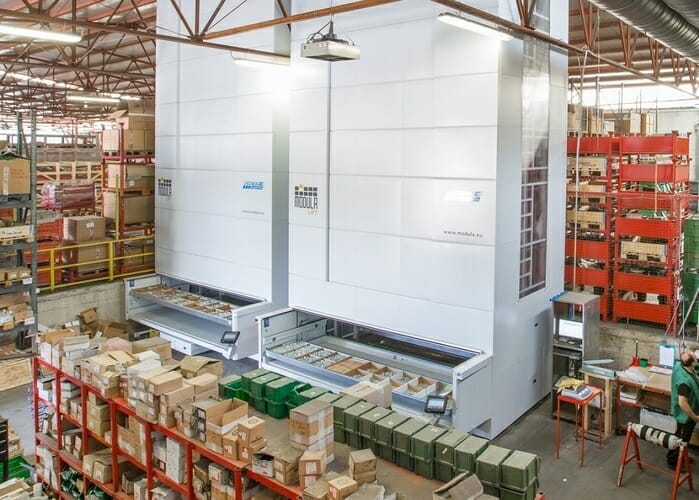 Vertical Lift module in a warehouse surrounded by pallet storage