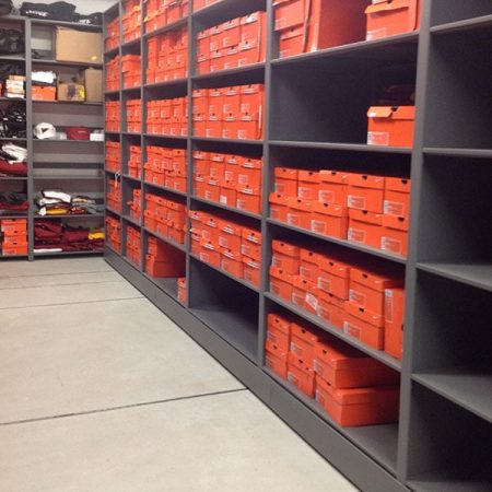 College athletic equipment shoe storage, cubbies are filled with bright orange Nike boxes
