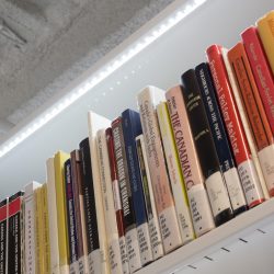 A row of books on Library shelving at Mount Royal University